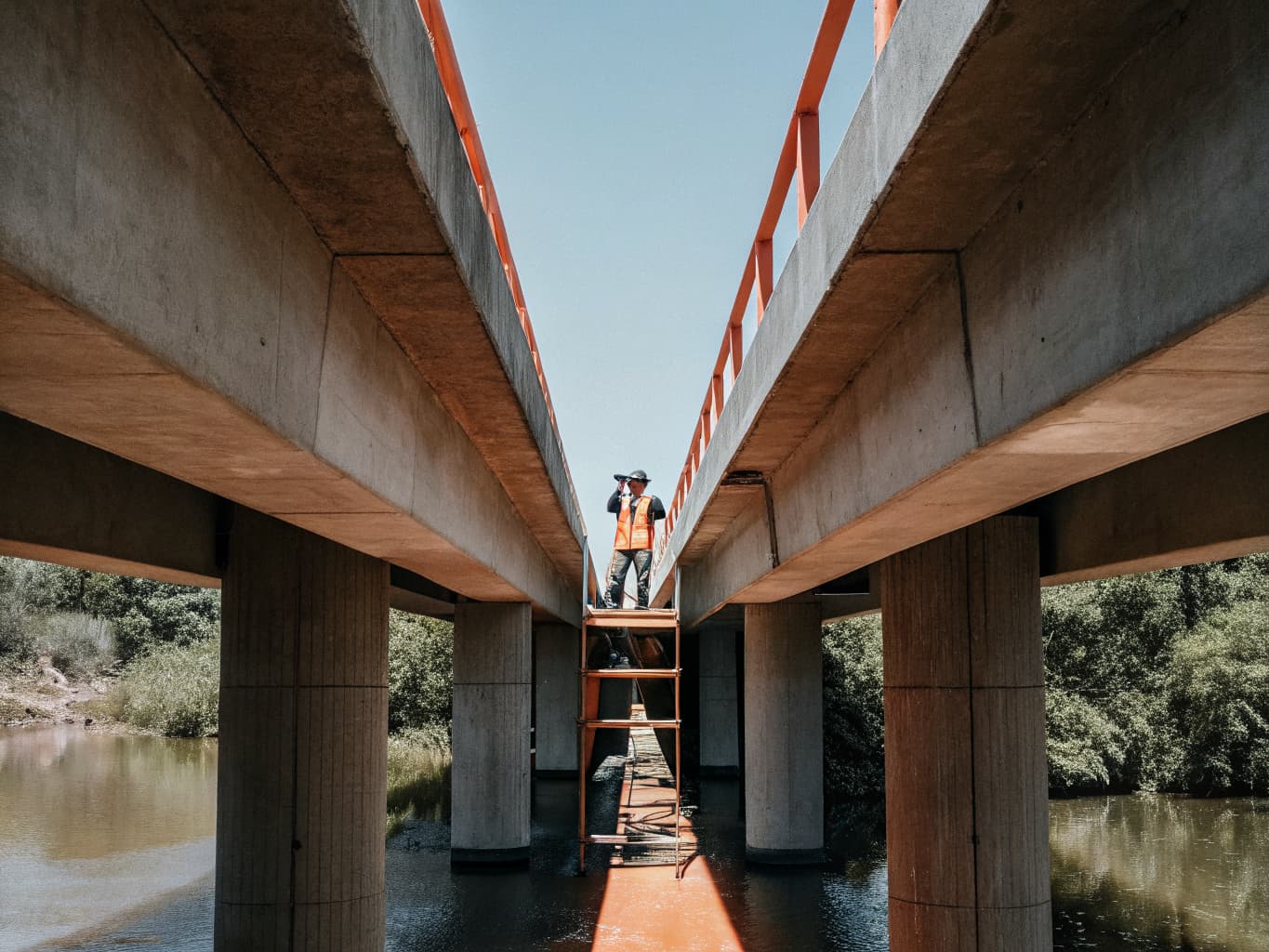 Industrial inspection drone hovering near bridge structure for close-range structural assessment